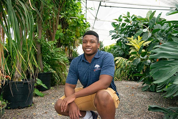 Johnathan Hampton in a greenhouse.