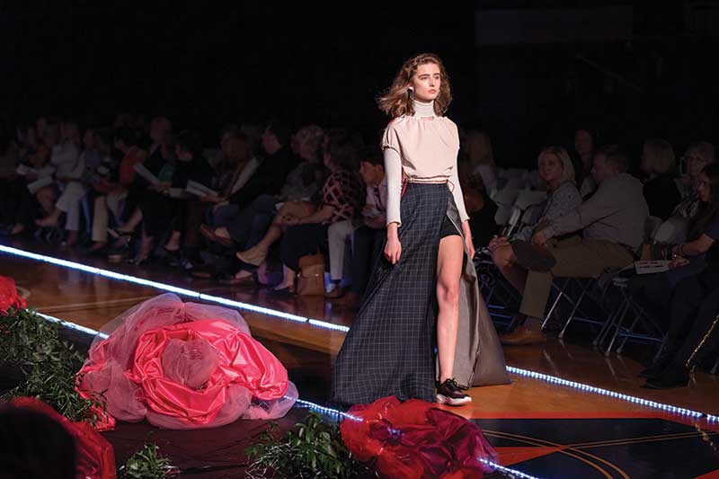 A model walks a runway at a fashion show