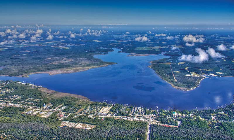 An aerial view of a lake and land
