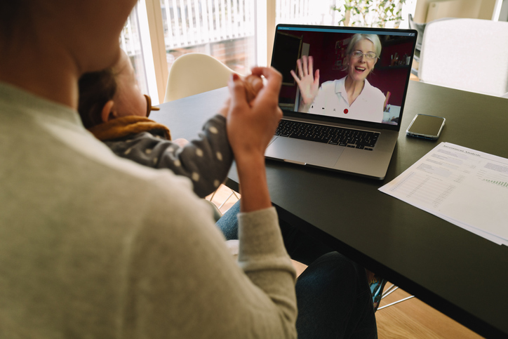 A woman talks on a tele-conference
