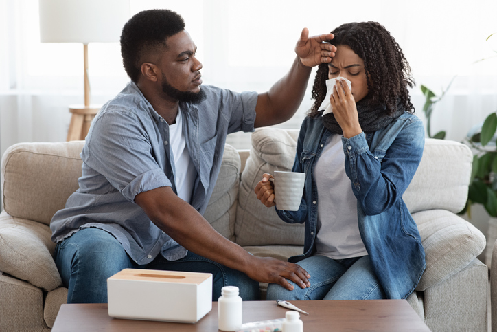 Black husband cares for his black wife while she is sick
