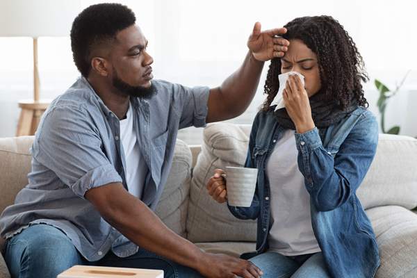 Black husband cares for his black wife while she is sick