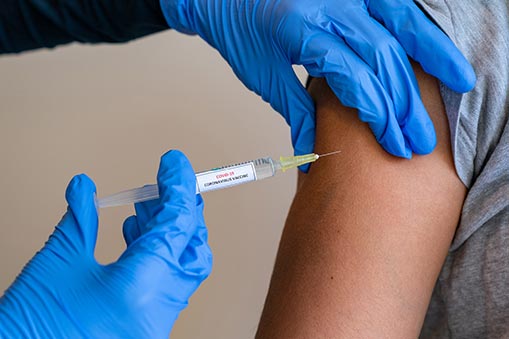 A patient receives a vaccine shot.