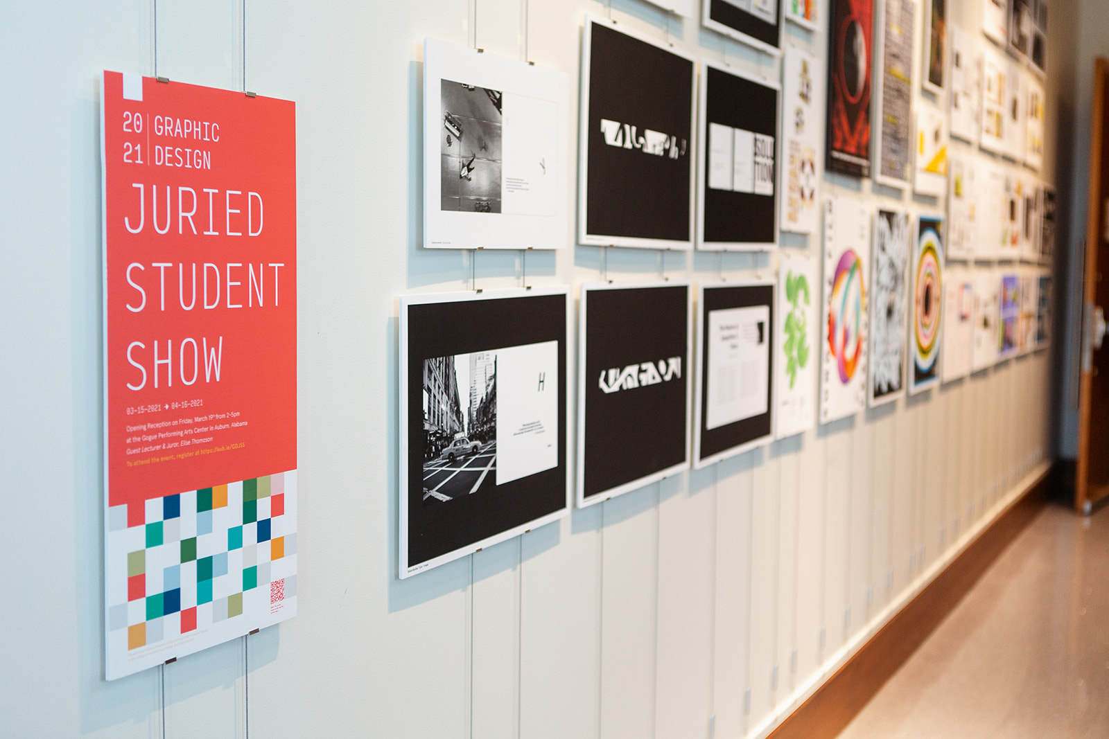 A wall of graphic design projects.