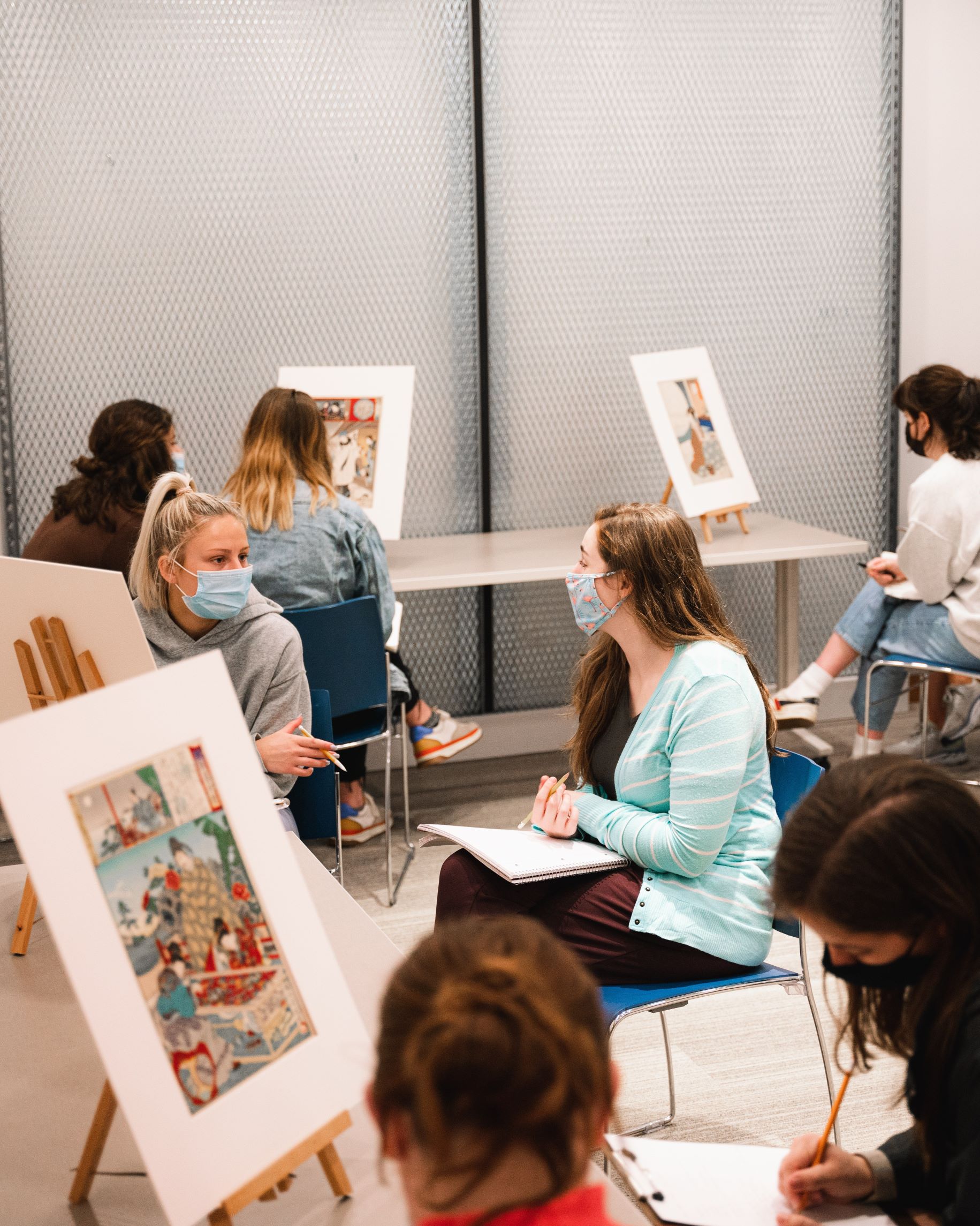 Art students looking at paintings