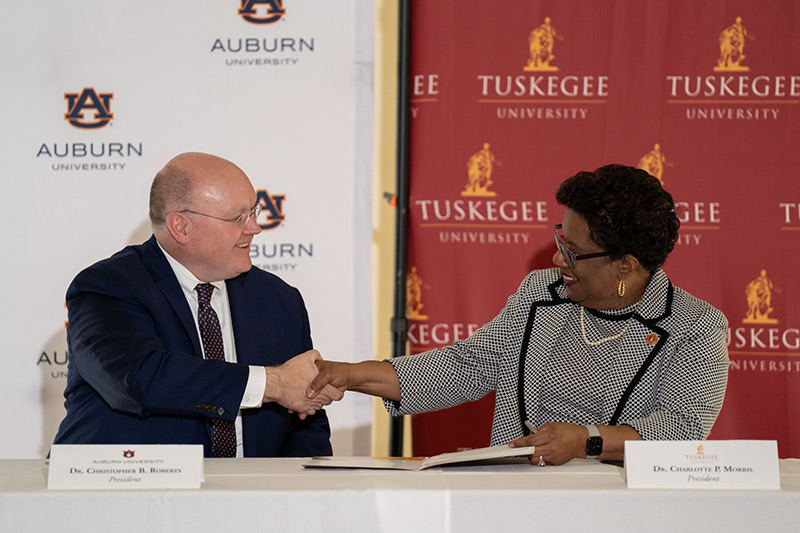 Auburn President Christopher B. Roberts shakes hands with Tuskegee President Charlotte P. Morris.