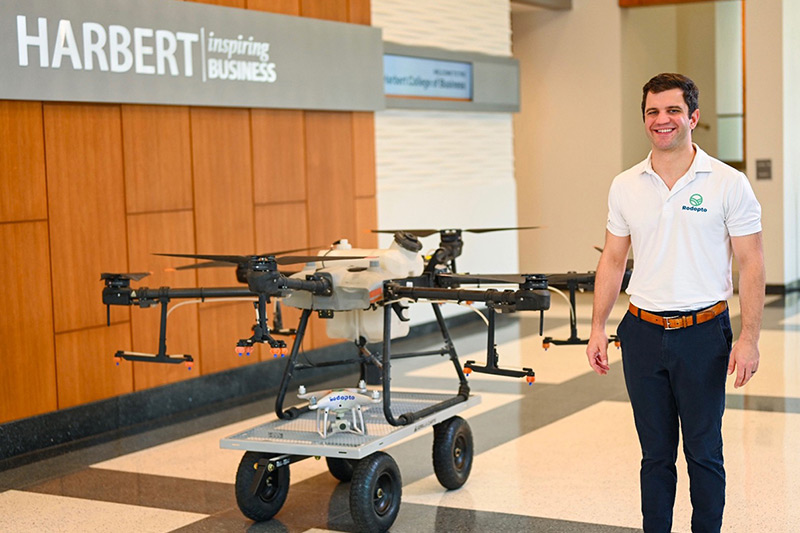 Scott Rowe next to a drone