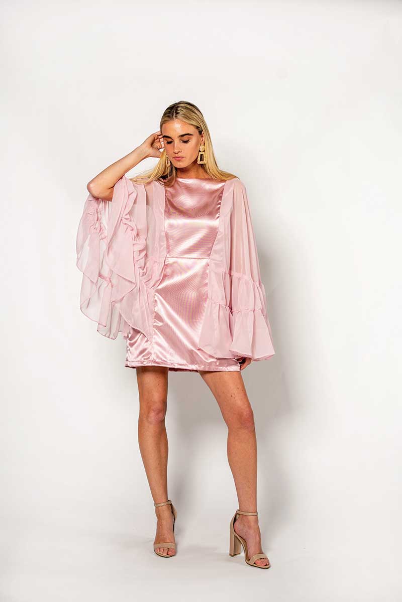 A model in a pink dress poses