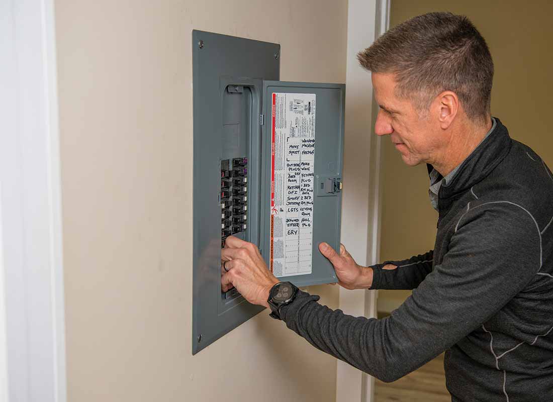 Rusty Smith looks in an electrical panel