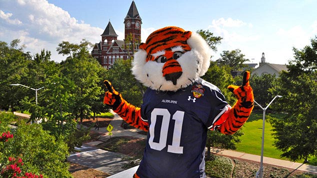 Aubie poses for a photo with the Samford Hall clocktower in the background.